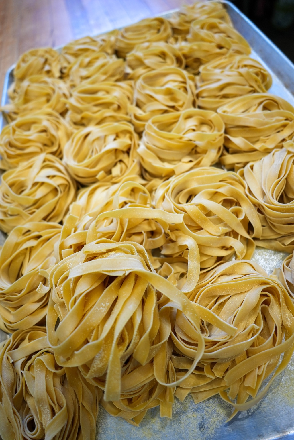 Rows of fresh handmade pasta nests